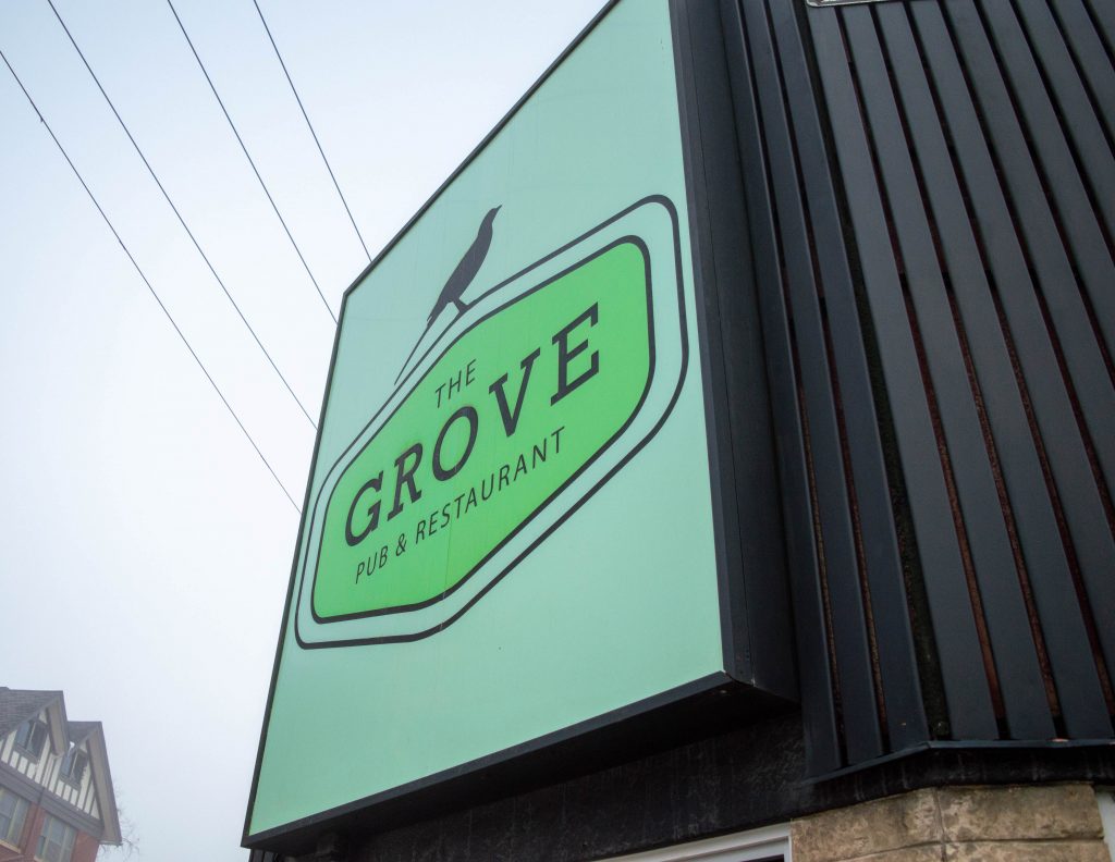 The big green sign of The Grove Pub & Restaurant