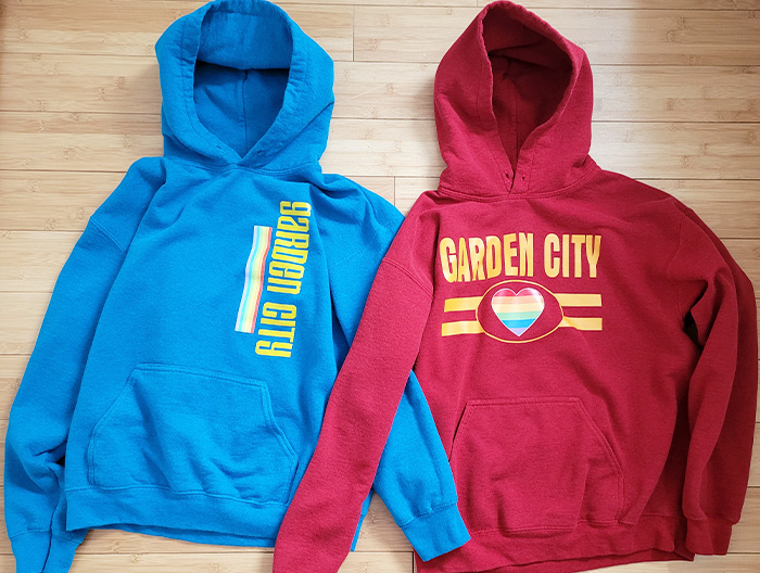 Two hoodies from the Pride merchandise line (red and blue).