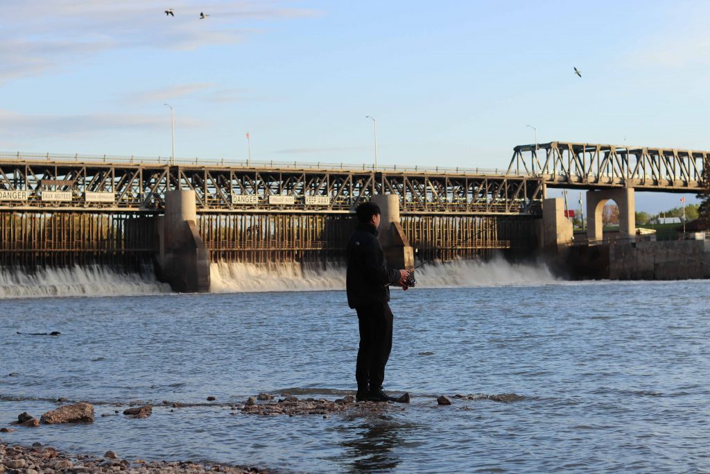 A man fishing on the Red River in Lockport. / CHLOE POMMER