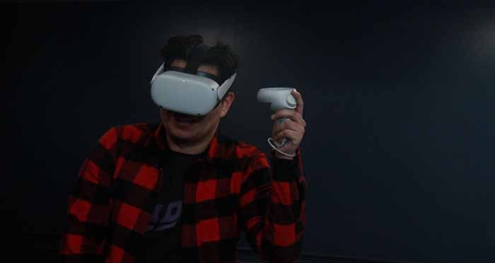 a young man playing with the Oculus Quest 2