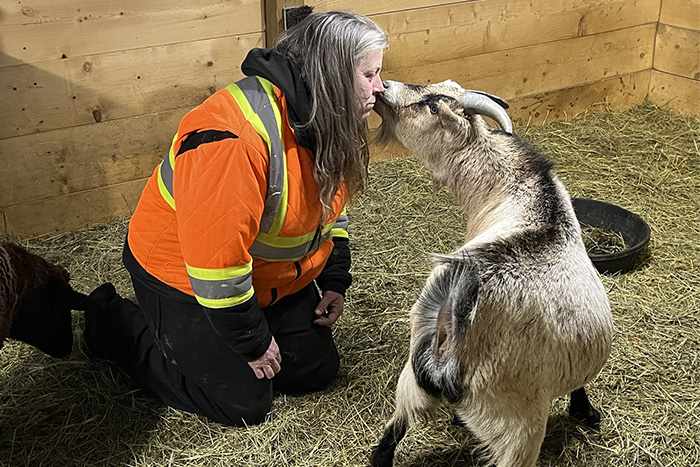 Tara McKean kisses her goat.
